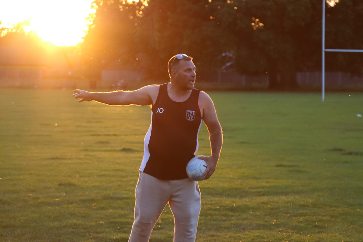 Player passing the ball in evening light