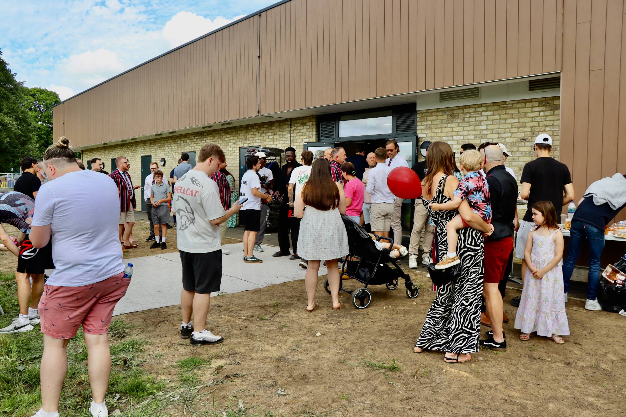 Members, families and supporters gathered outside the clubhouse entrance